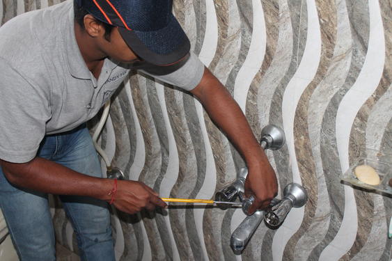 a plumber working on tap