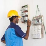 an electrician working on electric panel