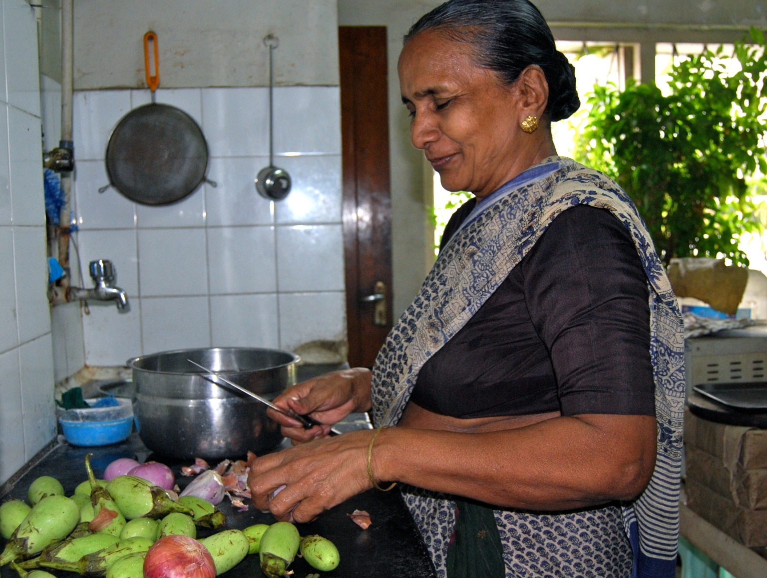 an old lady working in kitchen